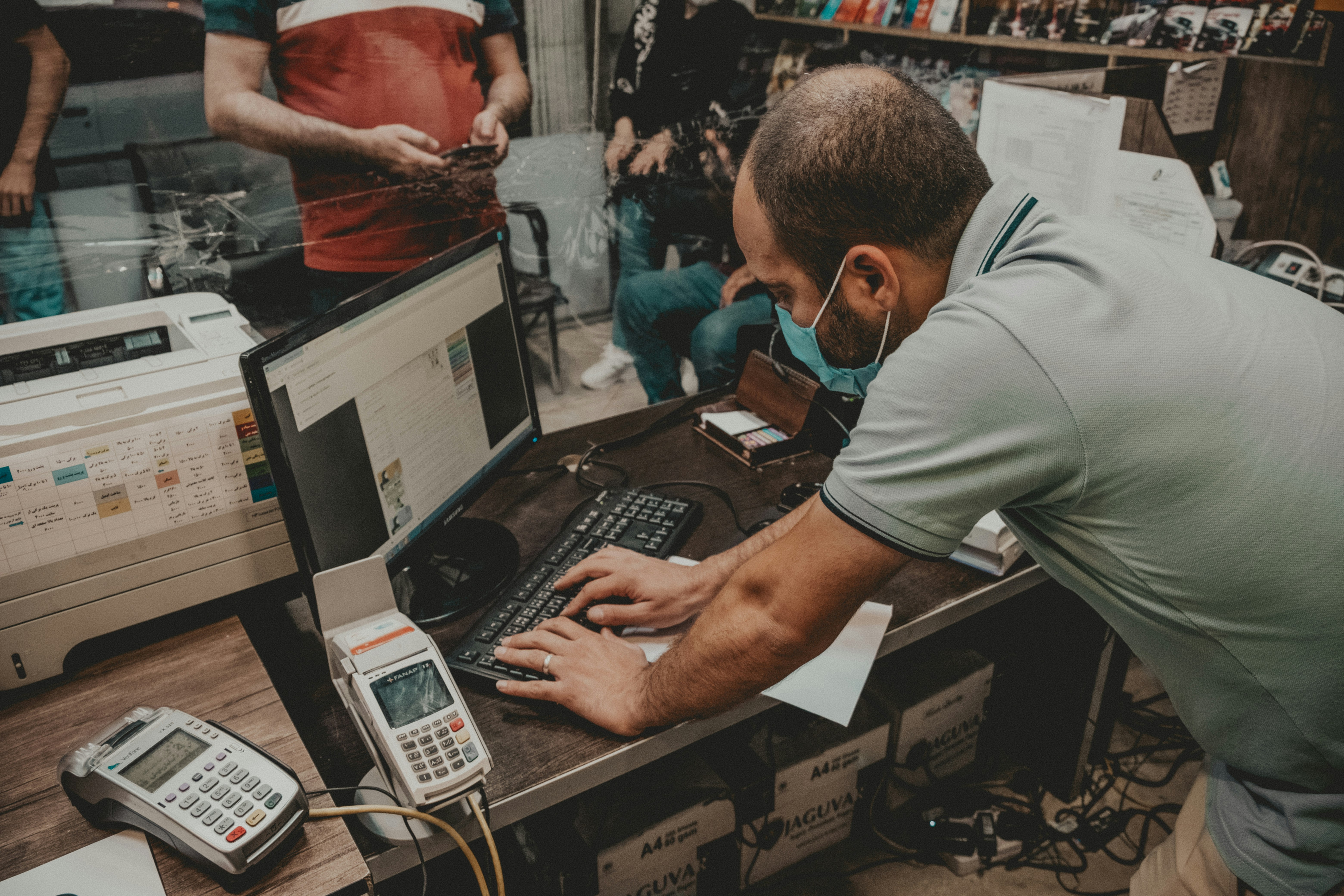 man in gray polo shirt using black laptop computer